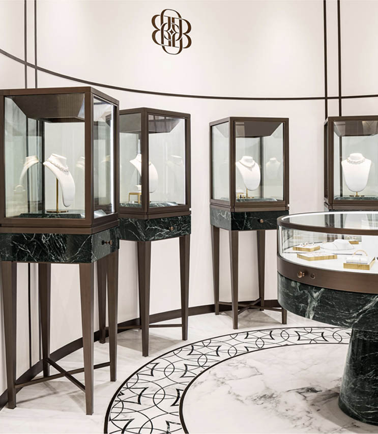 Luxury jewelry display in a store with marble and glass cases