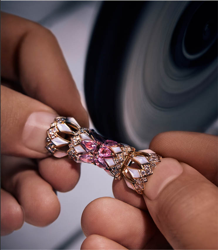 Close-up of hands holding a luxurious jewelry piece with intricate design and gemstones